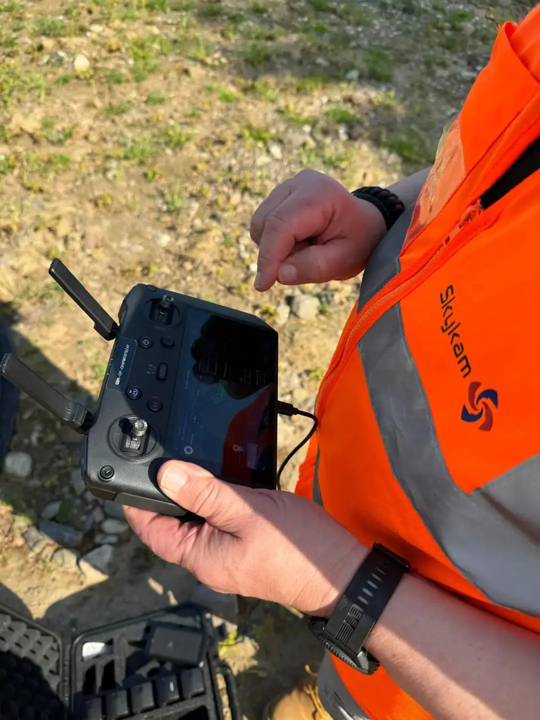 James Leslie flying a survey mission from the remote controller on site